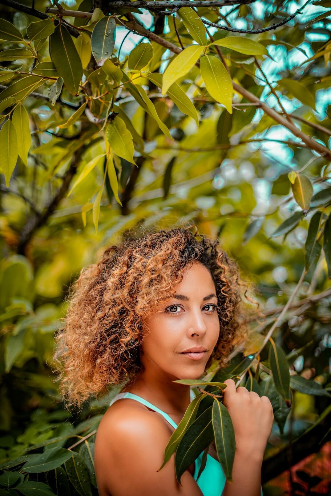 Studio portrait of a Brazilian woman with curly hair smiling