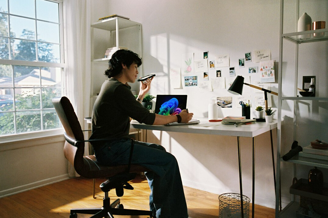 person writing notes at desk