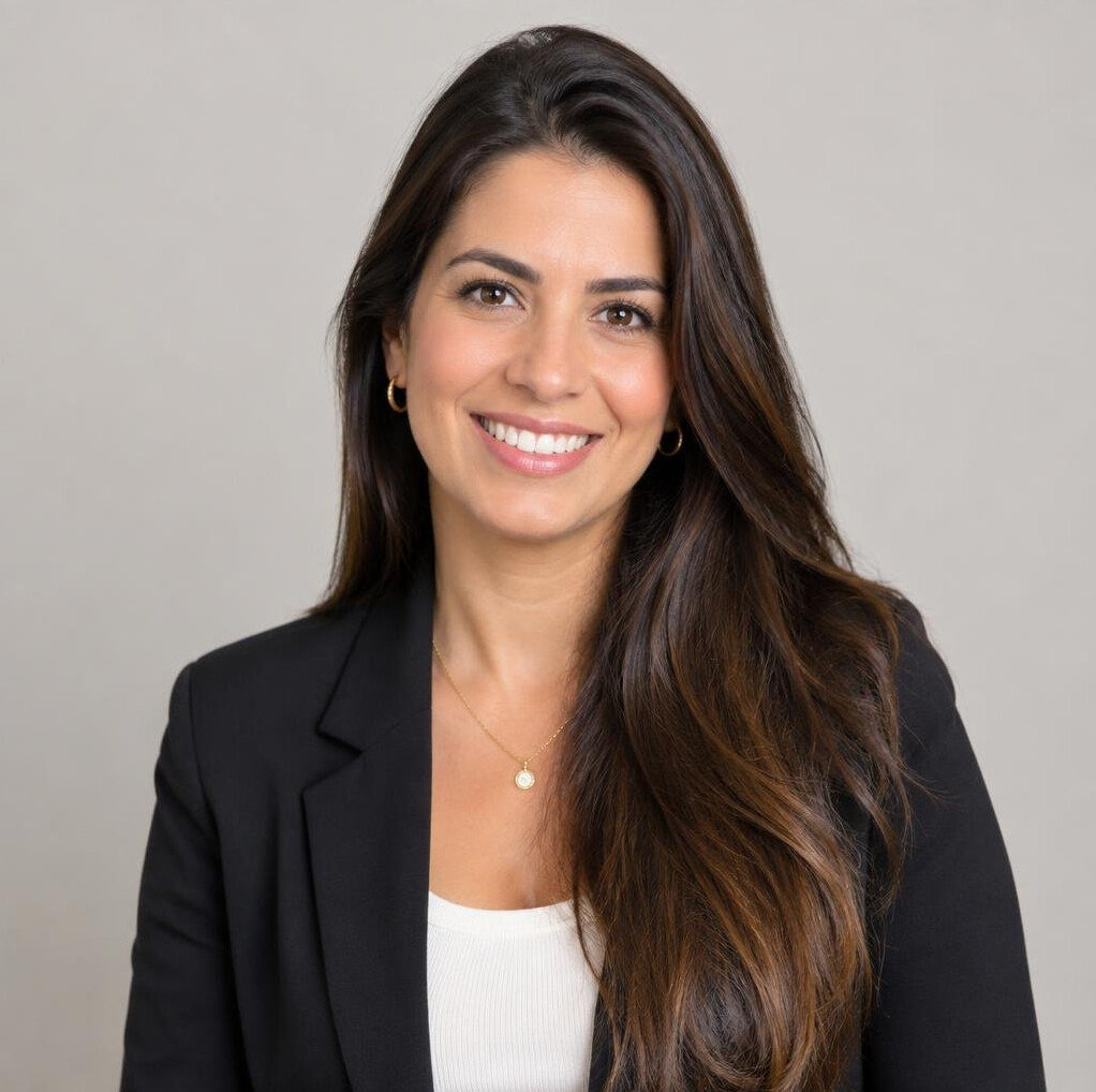 Studio portrait of a Brazilian woman with brown hair smiling
