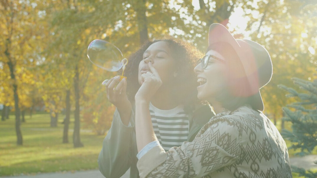 Two friends having an animated conversation in a park