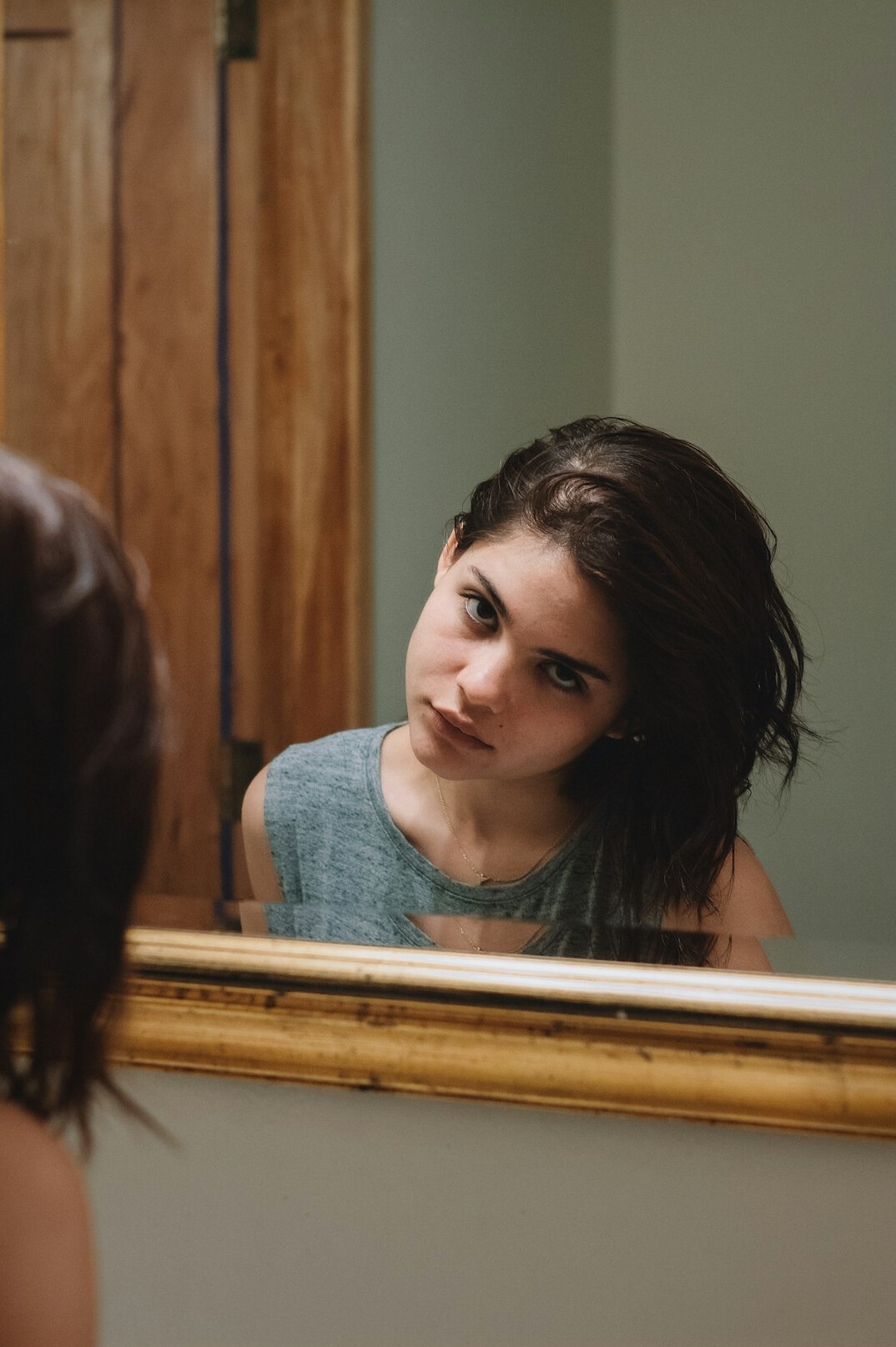 person reflecting in mirror