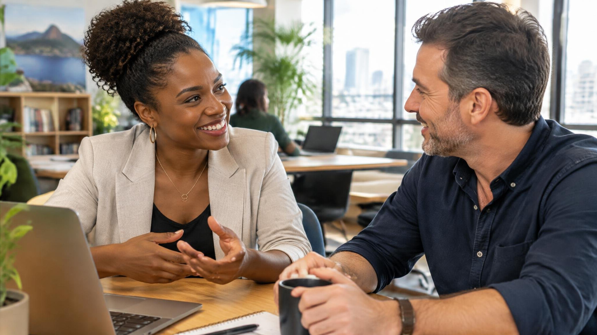 Two Brazilian professionals having a warm conversation in a bright office